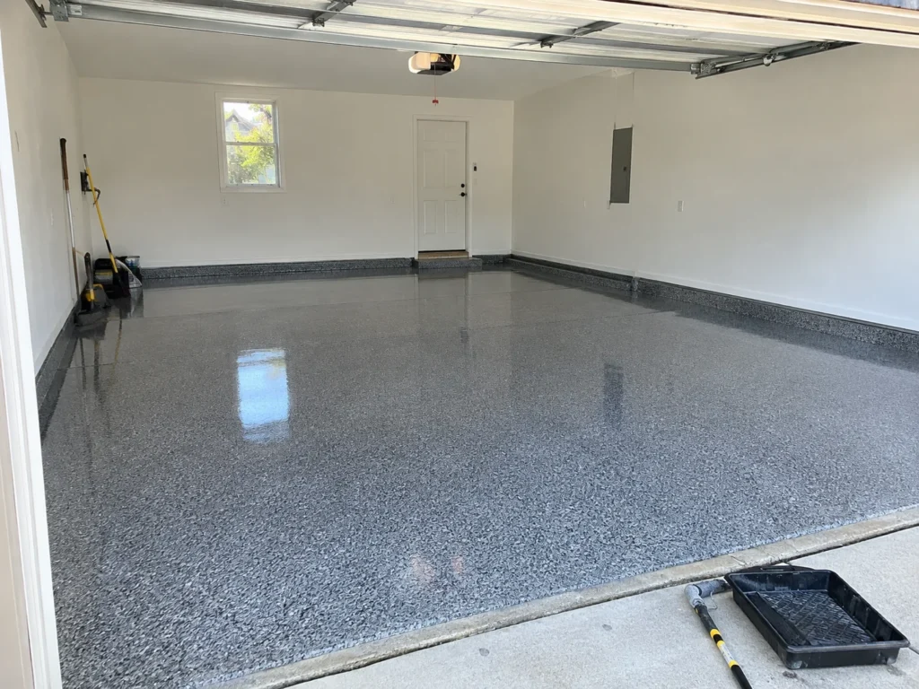 Finished gray flake epoxy floor in a 2-car garage after professional installation